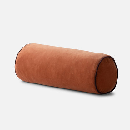Angled front view of Velvet Piped Pillow (bolster) showcasing tawny cotton velvet and contrast piping on white background
