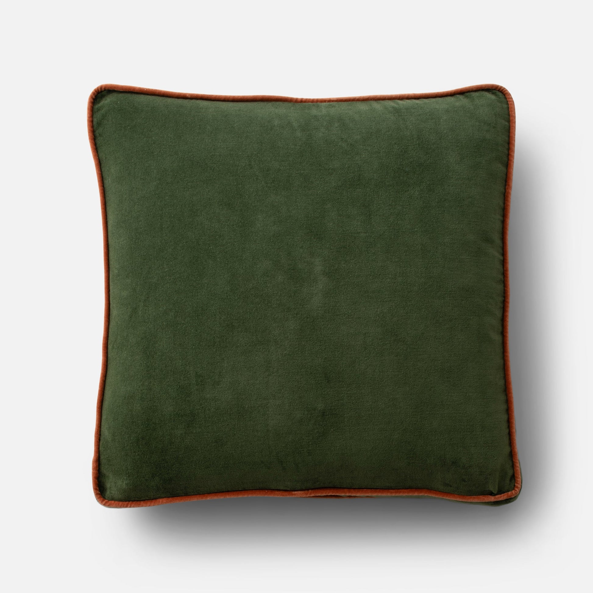 Overhead of Velvet Piped Pillow showcasing forest green 100% cotton velvet with rust contrast piping on light gray background