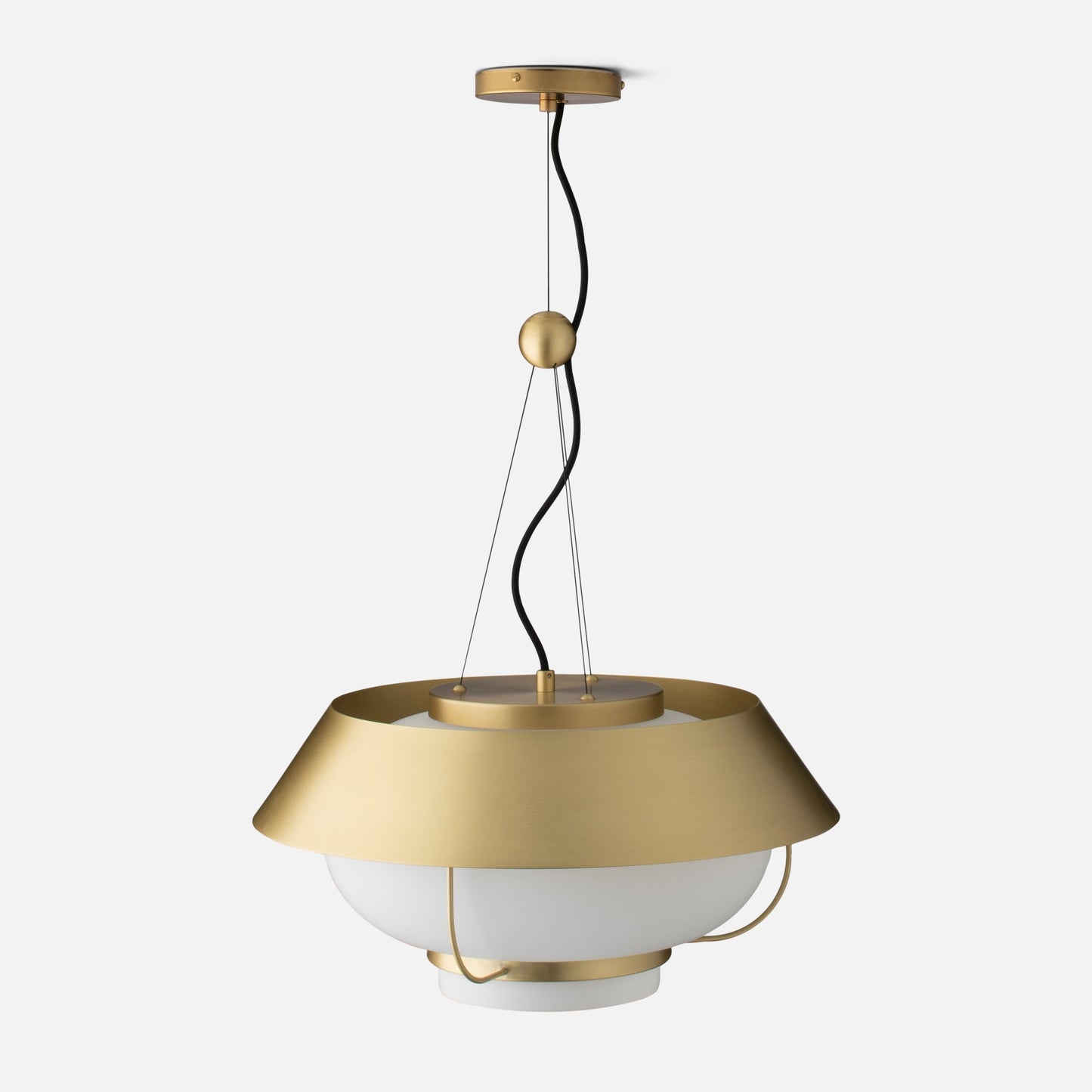 Front close up of Alfred Pendant showing natural brass canopy, twisted black cord, and white opal glass diffuser on light gray background