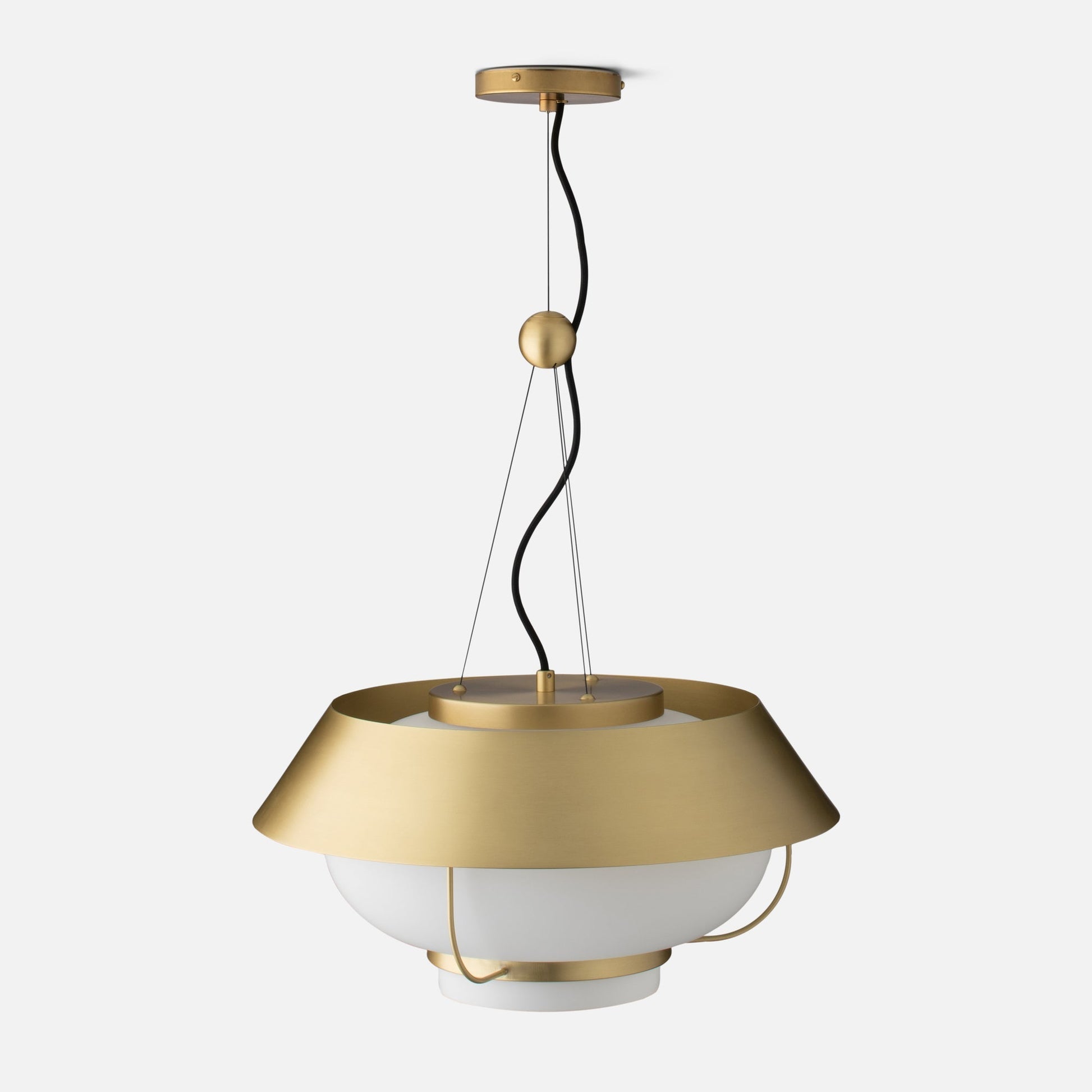 Front close up of Alfred Pendant showing natural brass canopy, twisted black cord, and white opal glass diffuser on light gray background