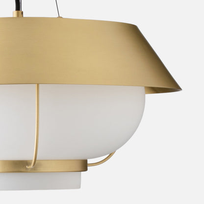 Close-up right-side view of Alfred pendant showing natural brass shade and white opal glass diffuser against light gray background