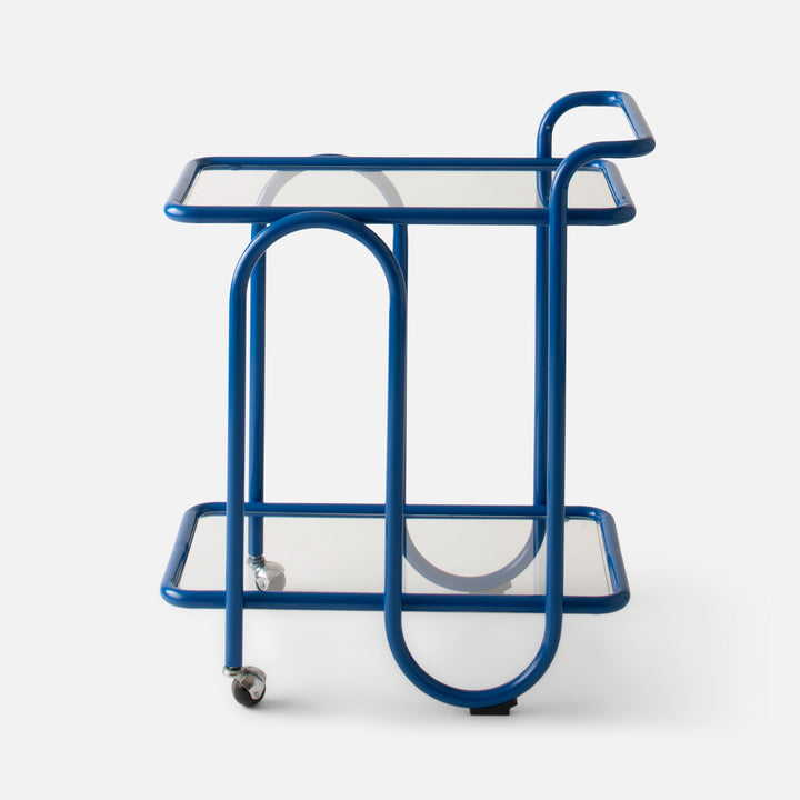 Front view of Lolly Bar Cart showcasing cobalt gloss bent steel frame, two tempered glass shelves and caster wheels on white background