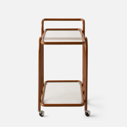 Front view of Lolly Bar Cart showing butterscotch bent steel frame, glass shelves and caster wheels on white background
