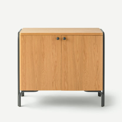 Front view of Forma Cabinet showcasing oak veneer doors, matte black metal frame and round black knobs on white background