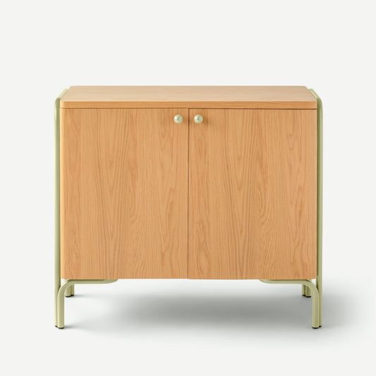Front view of Forma Cabinet showing oak veneer double doors, round knob handles and pale green metal frame on white background