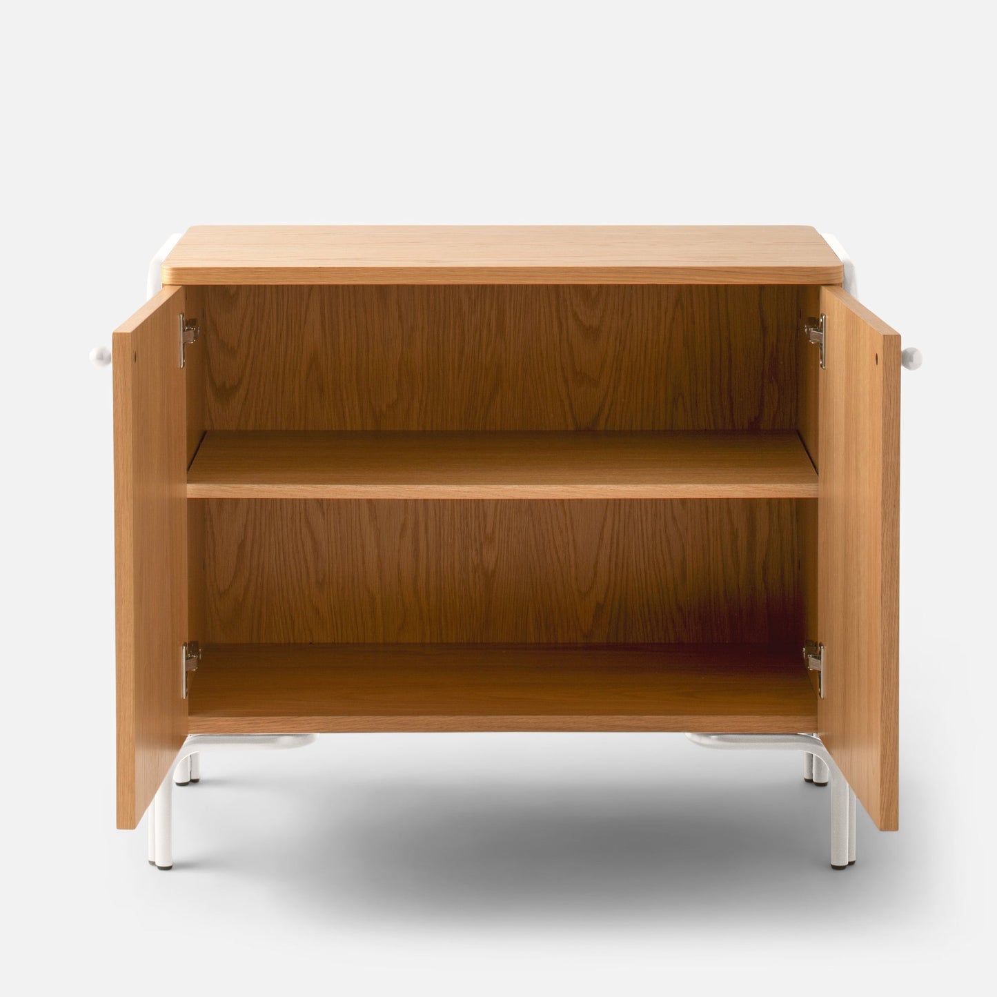 Front view of Forma Cabinet with open doors showing oak veneered interior shelves and white powder-coated steel legs on a white background