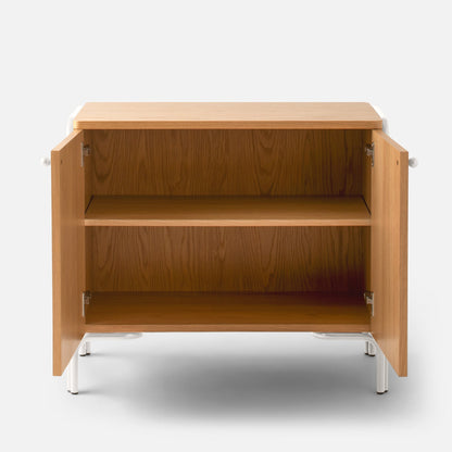 Front view of Forma Cabinet with open doors showing oak veneered interior shelves and white powder-coated steel legs on a white background