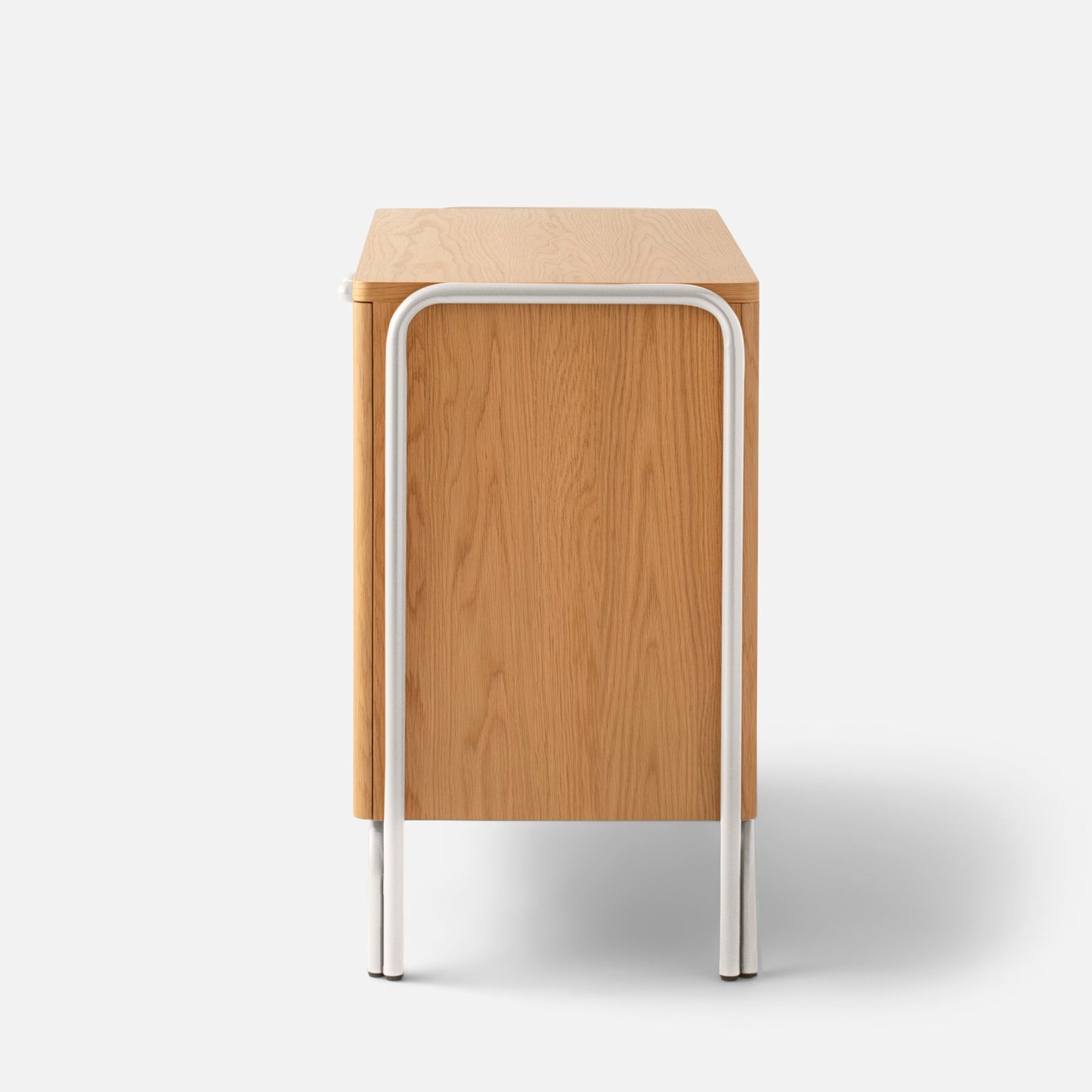 Side view of Forma Cabinet showing oak-veneered door and rounded white powder-coated steel legs on a white background