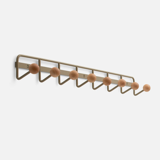 Angled view of Mollie Multi Hook showcasing seven oak knobs on a painted steel wall rack with white background