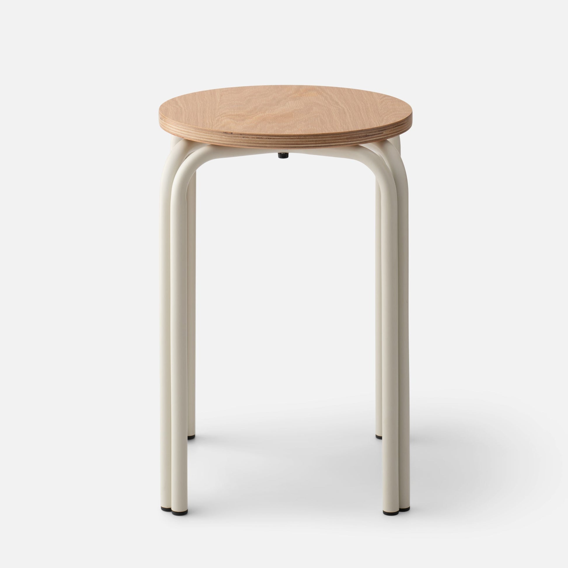 Front of Forma Stool showing round oak top with exposed plywood edge and cream powder-coated steel legs on white background