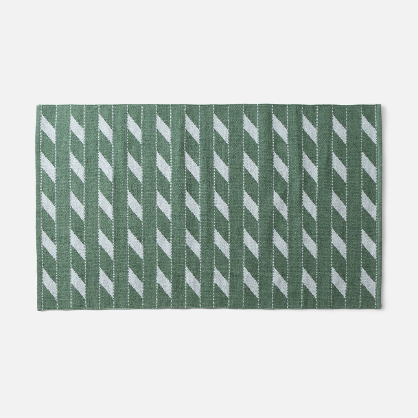 Flat-lay of Cotton Ladder flatweave rug showcasing green ladder stripe pattern and woven texture on white background