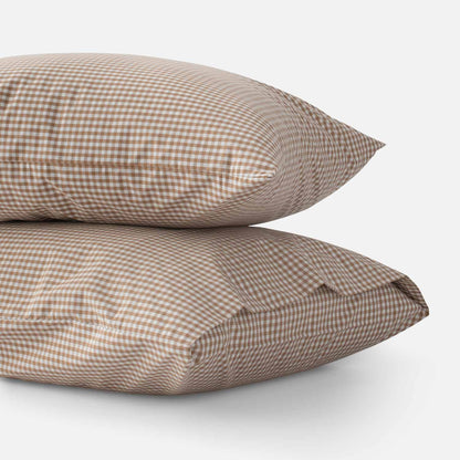 Side view of Gingham Pillowcase Set (two stacked pillowcases) showing russet gingham check on white background