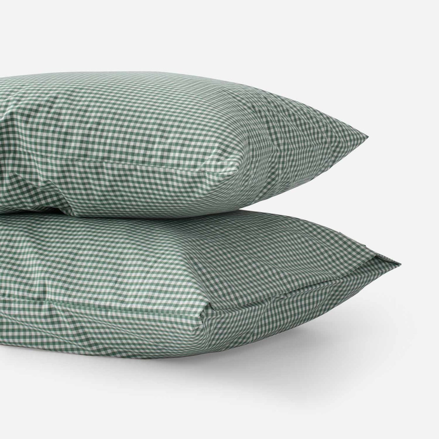 Side view of two Gingham pillowcases (set of 2) in juniper green gingham check showing cotton percale weave on white background