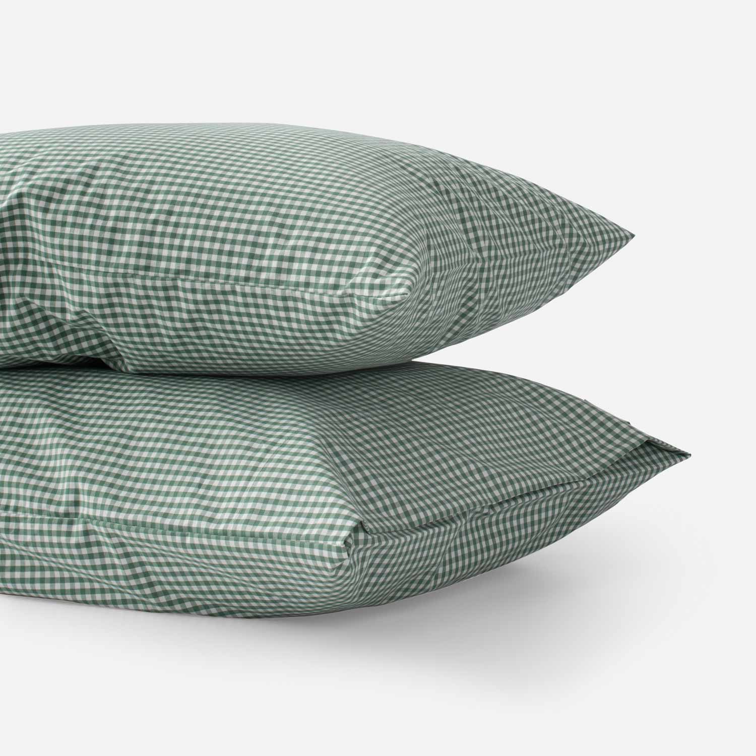 Side view of two Gingham pillowcases (set of 2) in juniper green gingham check showing cotton percale weave on white background