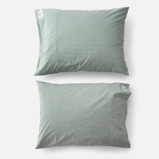 Top-down view of two Gingham Percale pillowcases (set of 2) showcasing juniper green gingham check pattern on white background