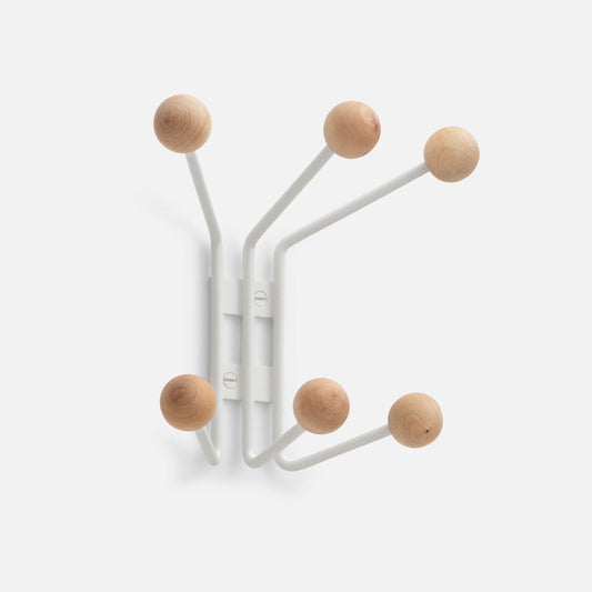 Angled front view of Mollie 6 Hook showcasing six white steel arms with natural oak ball knobs on light gray background