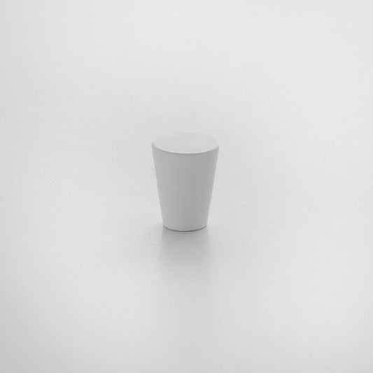 Front view of Newberg knob showcasing tapered conical shape and matte white finish on a light textured background