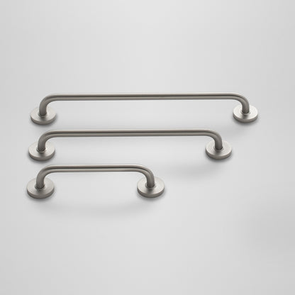 Angled view of three Parker Pulls showcasing satin nickel finish and round rosette mounts on light gray background