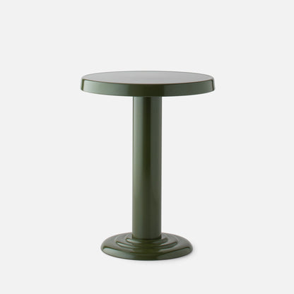 Close up front view of Owen Side Table showcasing glossy forest green round top and cylindrical pedestal base on a white background