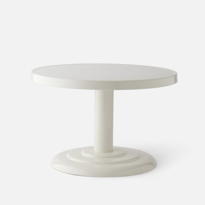 Front view of Owen Cocktail Table showcasing round tabletop and stepped pedestal base in shell white gloss on light background