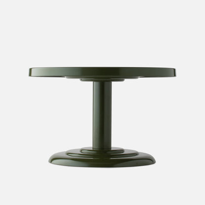 Low-angle front view of Owen Cocktail Table showcasing alder-gloss round top edge and central pedestal on white background