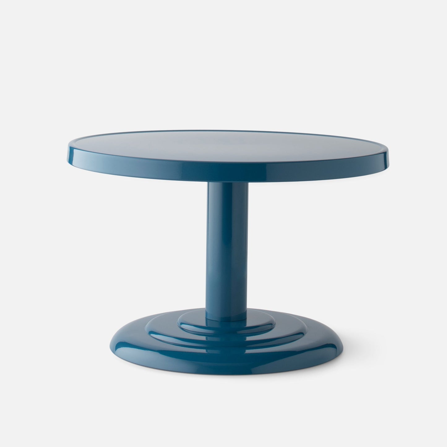 Close-up front view of Owen Cocktail Table showcasing round tabletop, stepped pedestal base, and Pool-Gloss finish on a light background