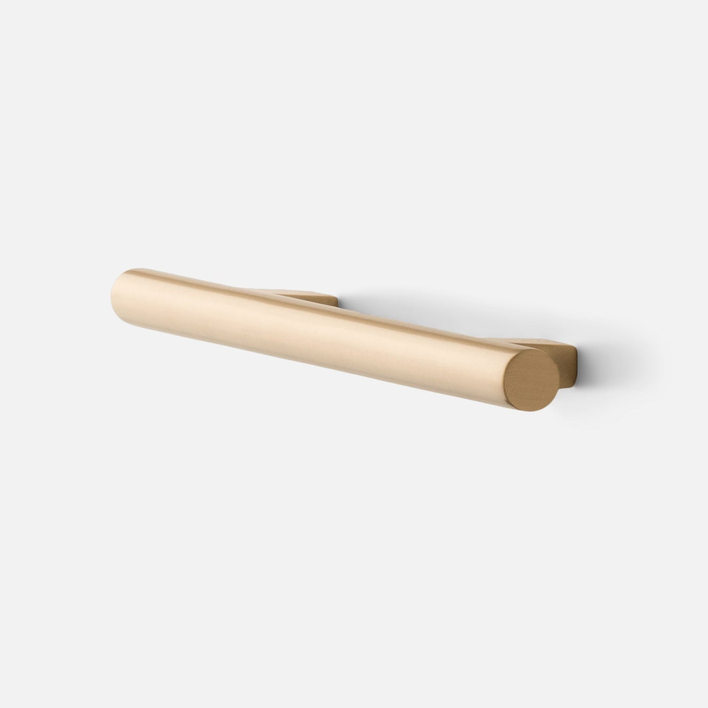 Angled view of Galley Pull in natural brass showing cylindrical bar with rounded ends on white background