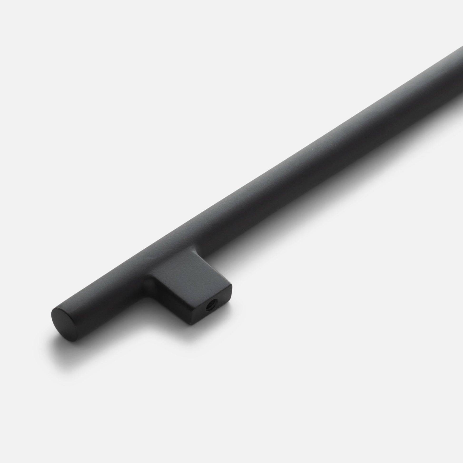 Diagonal close-up of Galley Pull showing matte True Black cylindrical bar and square mounting post on white background
