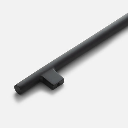 Diagonal close-up of Galley Pull showing matte True Black cylindrical bar and square mounting post on white background