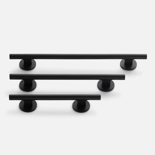 Angled view of Galley Pull set in three sizes showcasing matte black tubular bars with round mounts on a light gray background