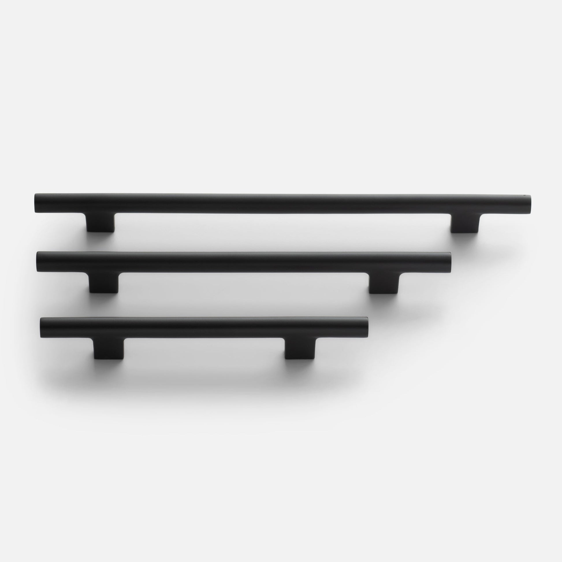 Front view of three True Black Galley Pulls showcasing tubular T-shaped design and matte finish on a white background