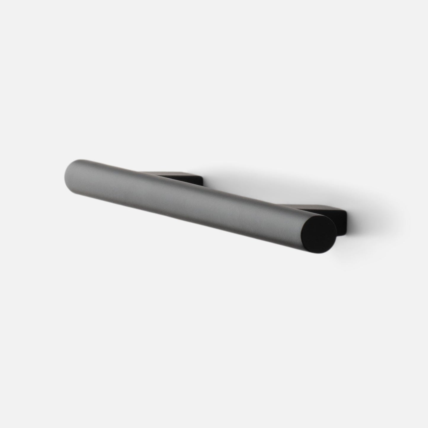 Angled side view of Galley Pull in true black showing cylindrical bar handle and square backplates on white