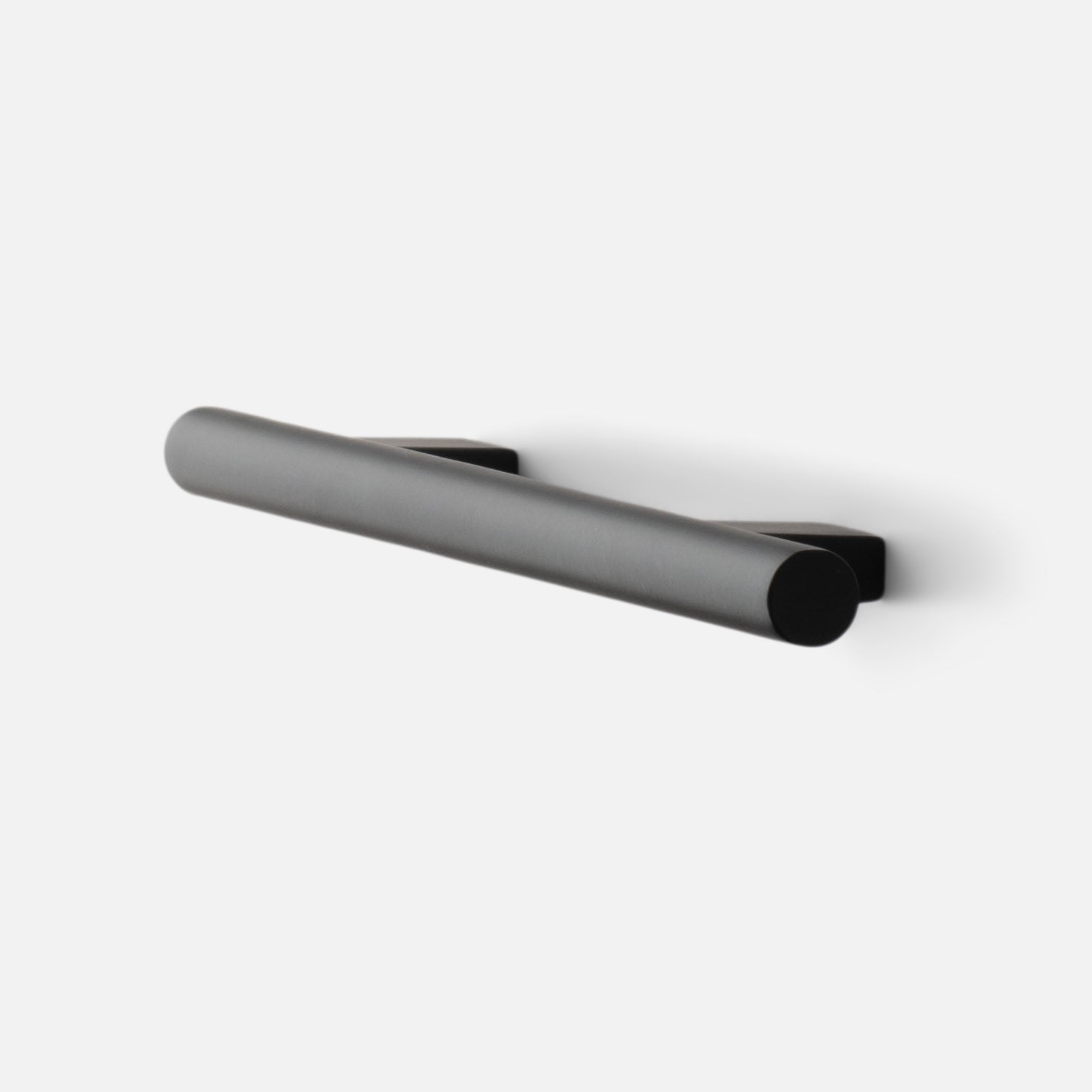 Angled side view of Galley Pull in true black showing cylindrical bar handle and square backplates on white