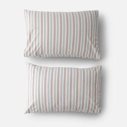 Top view of two Fresh Stripe percale pillowcases with blue and rust vertical stripes on white background