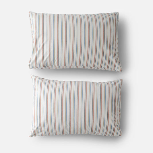 Top view of two Fresh Stripe percale pillowcases with blue and rust vertical stripes on white background
