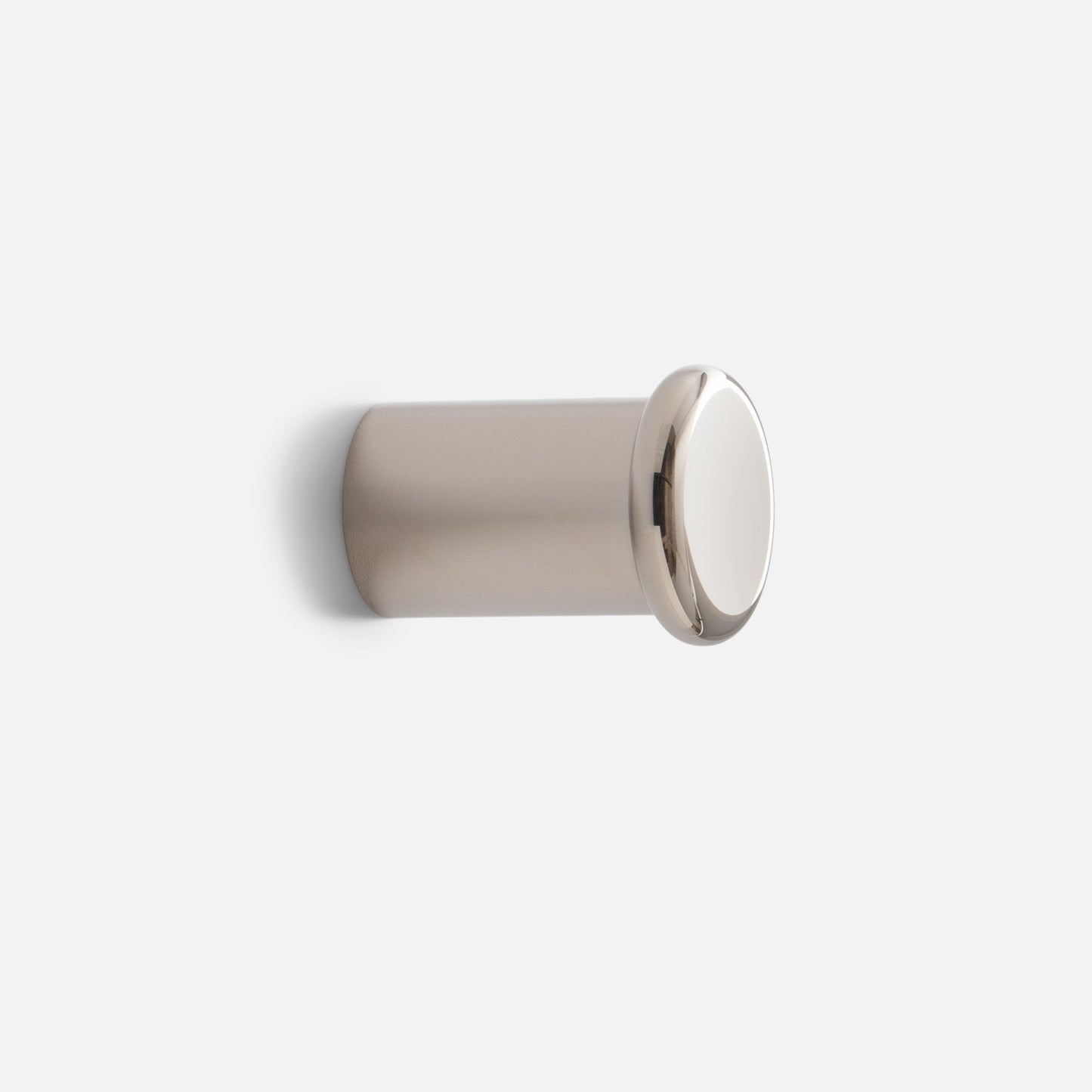 Angled side view of Remy Single Hook showcasing round cap and short cylindrical base with light gray background