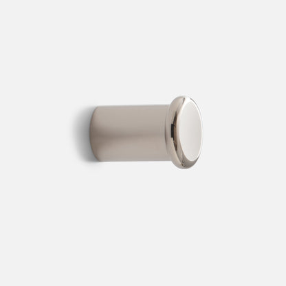 Angled side view of Remy Single Hook showcasing round cap and short cylindrical base with light gray background