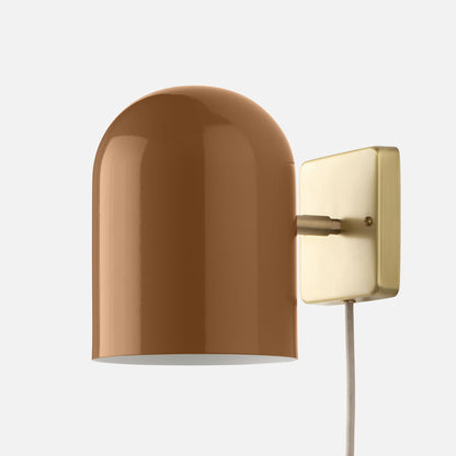 Close-up side view of Allegheny 6-inch plug-in sconce showing glossy brown shade, brass wall plate, and fabric cord