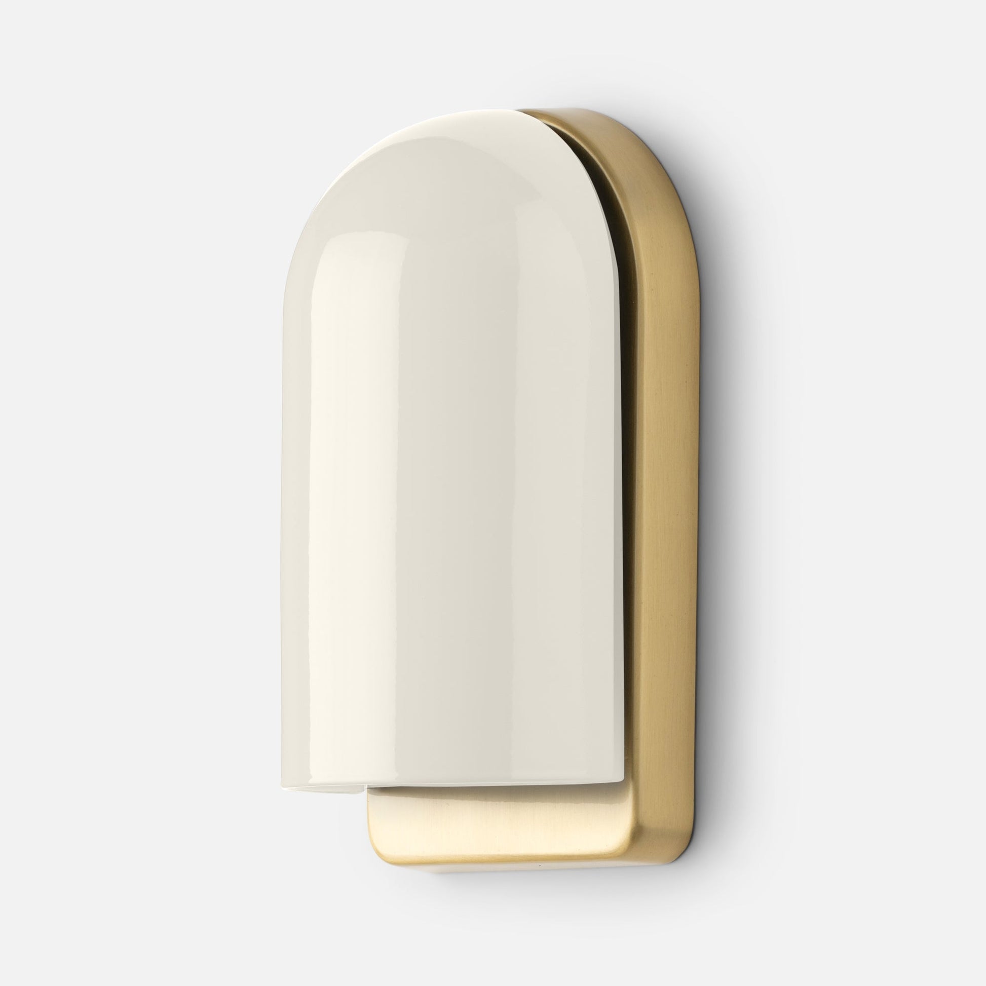 Close-up of Allegheny Slim Sconce showing glossy cream ceramic shade and brushed brass backplate on a light gray background