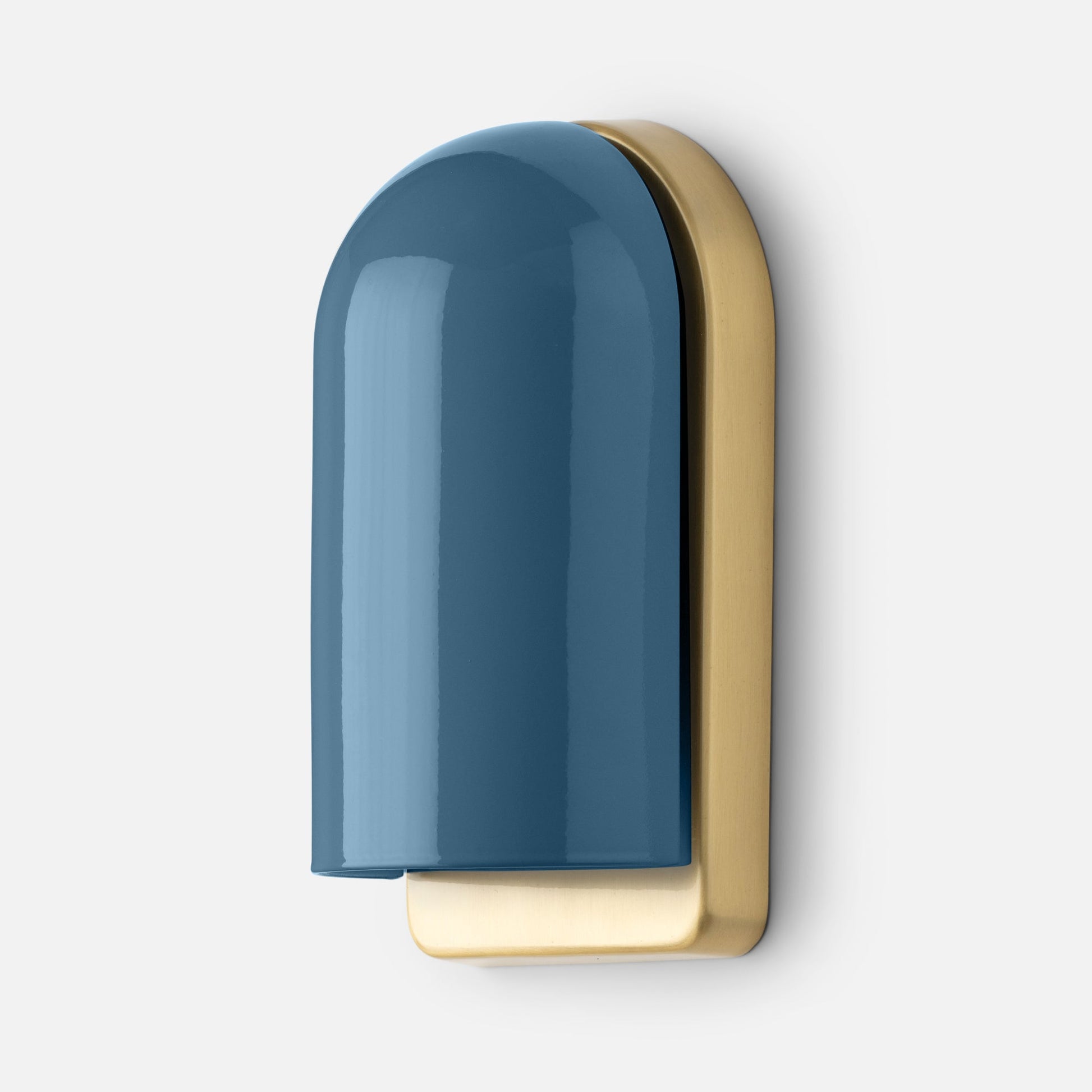 Close-up side view of Allegheny Slim Sconce showing glossy blue rounded shade and antique brass backplate on white background