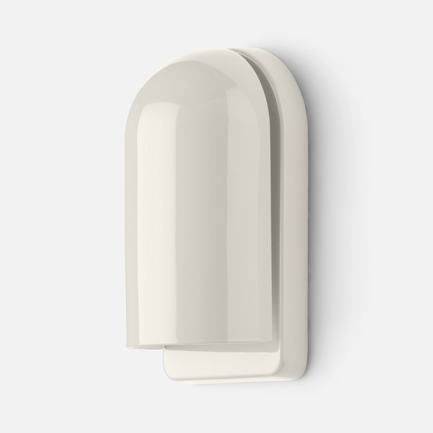 Close-up side view of Allegheny Slim Sconce showcasing its rounded glossy shade and layered backplate against a white wall