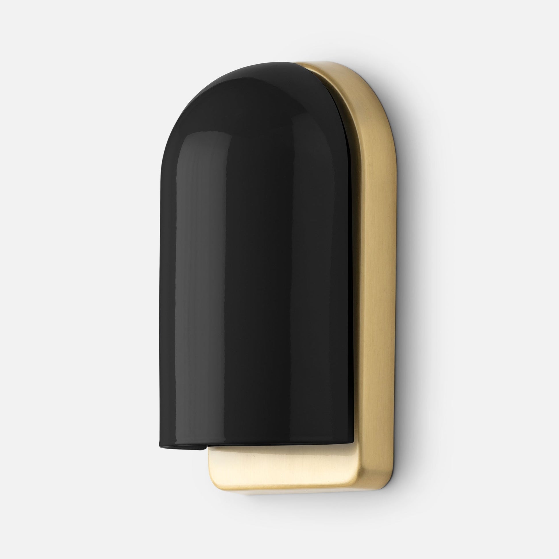 Close-up angled view of Allegheny Slim Sconce showcasing glossy black dome shade and brushed brass backplate on a white wall