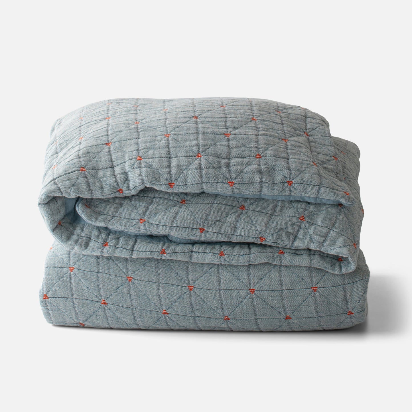 Folded Peak Stitch Duvet in olive with triangular quilting and red yarn tie stitches on matelasse fabric on white