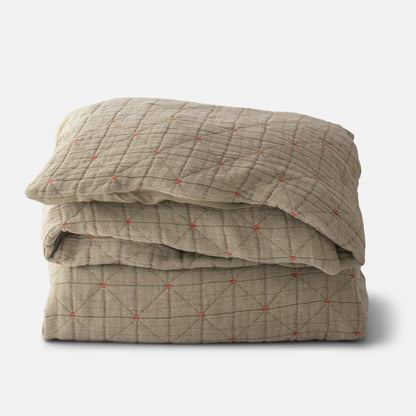 Folded Peak Stitch duvet showcasing diamond quilted stitch with small orange embroidered knots on white background