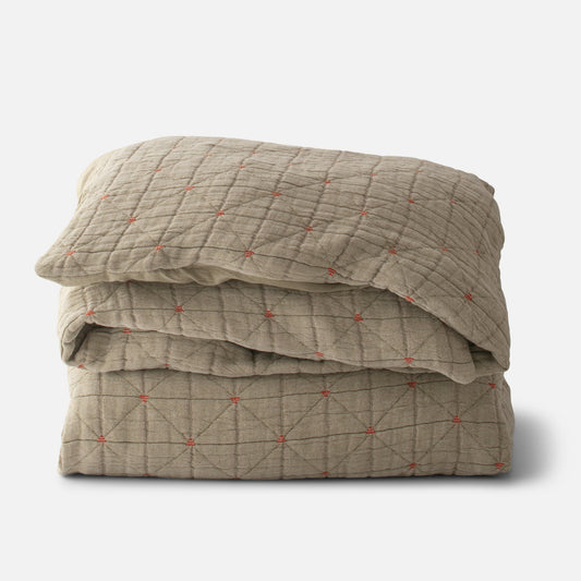 Folded Peak Stitch duvet showcasing diamond quilted stitch with small orange embroidered knots on white background