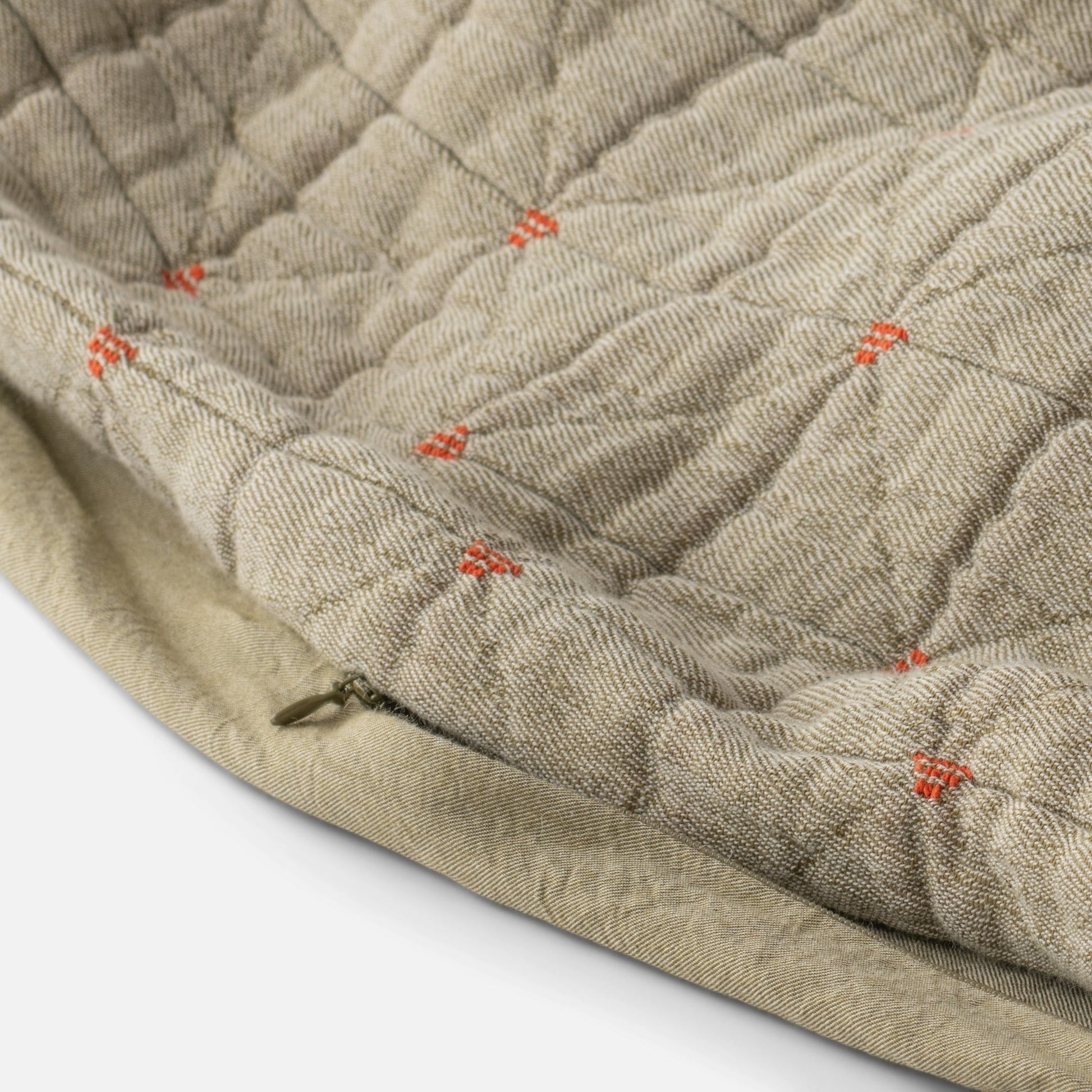 Close-up of Peak Stitch Duvet showing triangular quilting, yarn-dyed matelassé texture, red stitch ties and hidden zipper