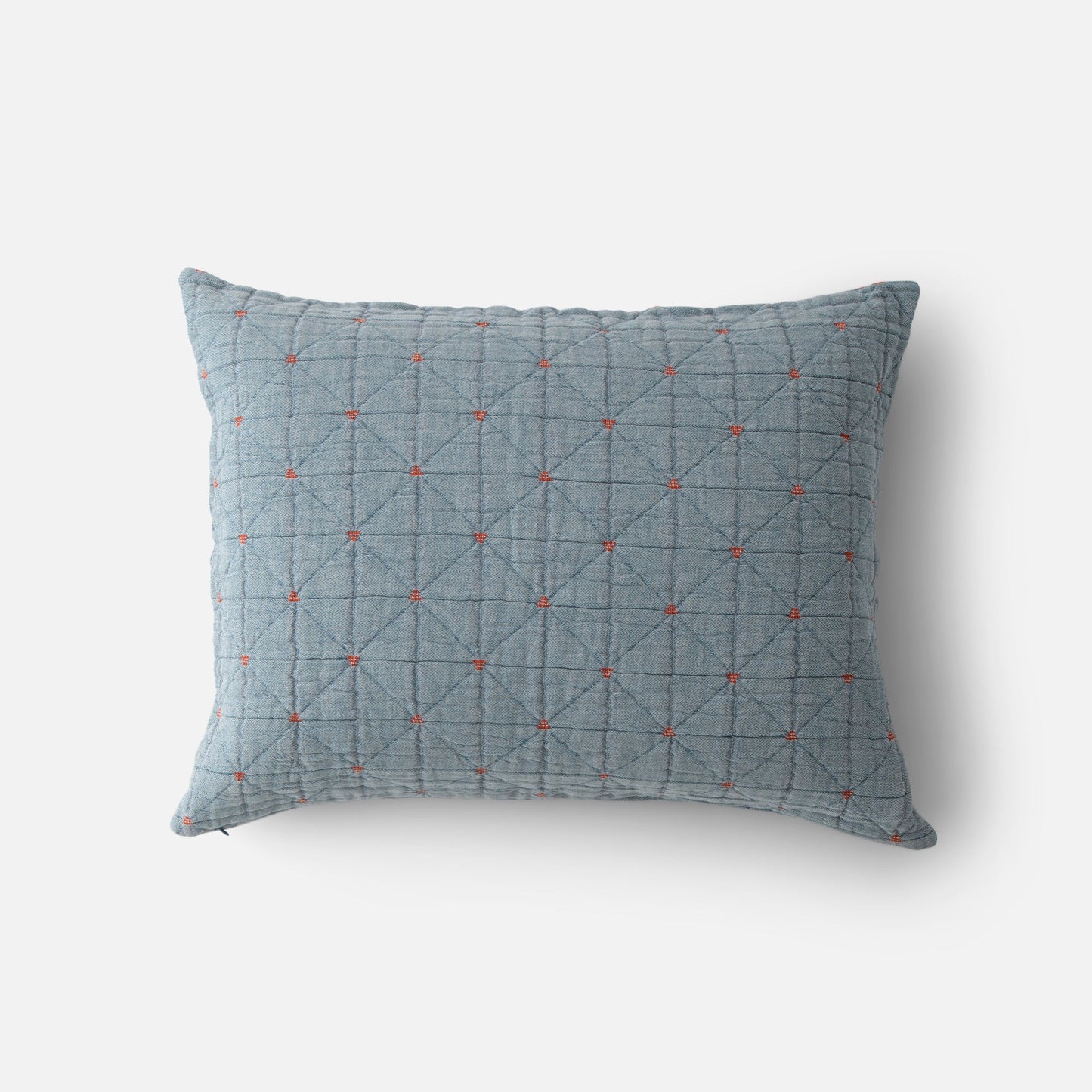Top view of Peak Stitch sham showing blue quilted fabric with diamond grid and small red embroidered crosses on white background
